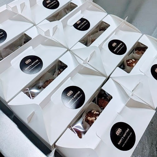 Half-dozen muffins arranged together, showing varied flavours in a bakery-style grouping