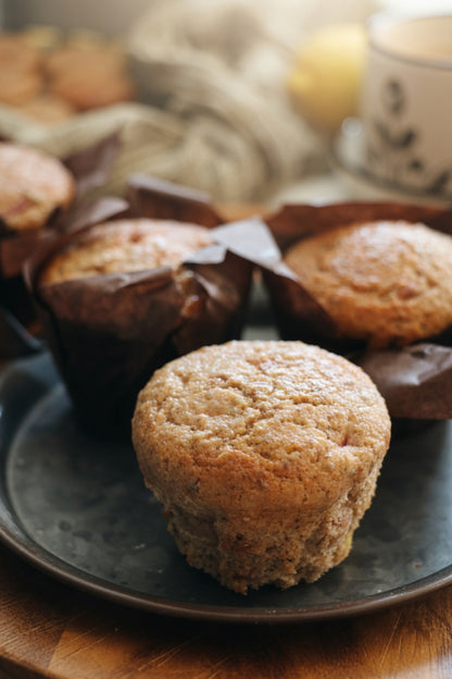Whole wheat lemony strawberry muffins on a dark plate, clean-label, nutritious, family-friendly Canadian muffins.