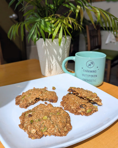 Close-up view of a high-fibre trail mix breakfast cookie showing pumpkin seeds, sunflower seeds, and dried cranberries sweetened with pure Canadian maple syrup.