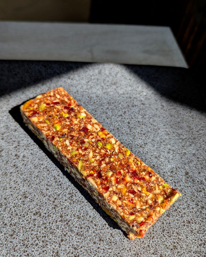 Rectangular cranberry protein bar with visible oats and nuts, clean-label, nutritious, family-friendly Canadian snack.